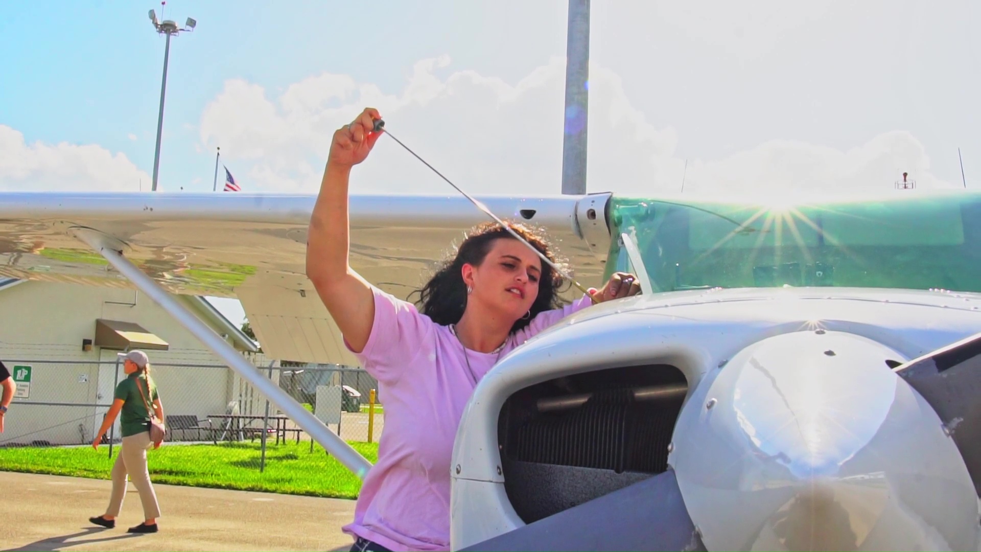 airplane mechanic checking oil