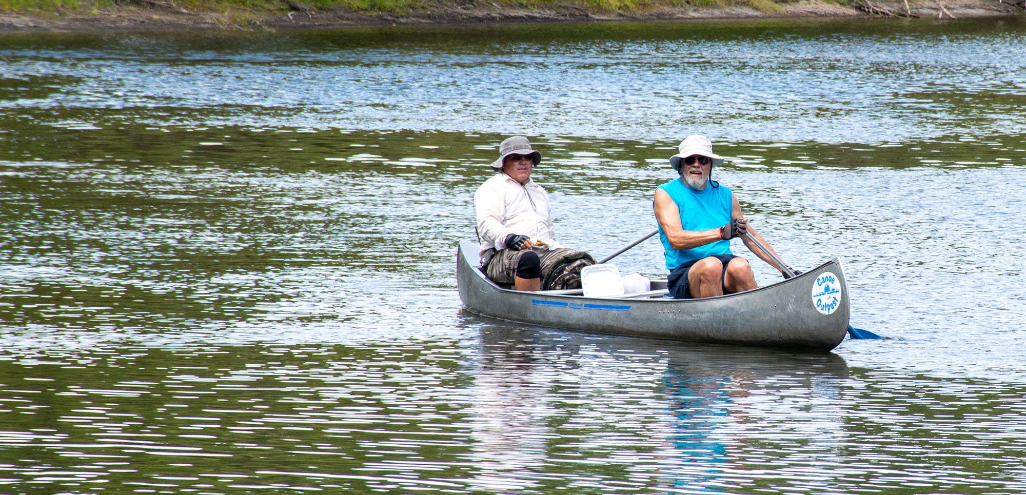 family canoeing on a lake