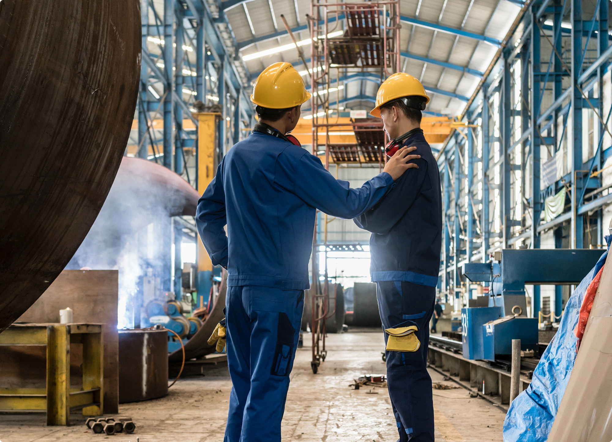 two workers in an industrial warehouse